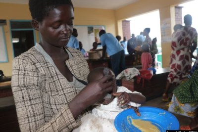 A mother feeds her child supplementary food at Mfera Health Centre in Chikwawa district in Malawi in October 2024 as more and more malnutrition cases are reported.