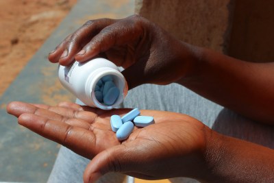 A woman in Kampala, Uganda, holds her HIV treatment drugs in May 2022. Hundreds of thousands of Ugandans living with HIV are not on antiretroviral medication, and concerns are growing that a US executive order could affect access to HIV prevention and treatment, largely funded by PEPFAR.